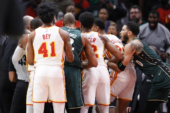 Teammates breakup a fight between Atlanta Hawks guard Trae Young (11) and Boston Celtics guard Marcus Smart (36) during the second half of an NBA basketball game, Saturday, March 11, 2023, in Atlanta. (AP Photo/Alex Slitz)