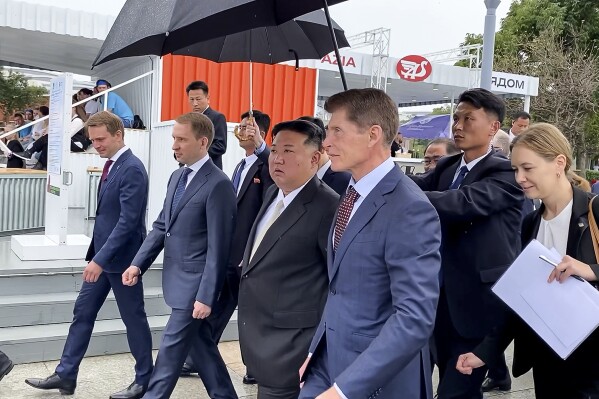 In this photo released by Government of the Russian far eastern region of Primorsky Krai, North Korea's leader Kim Jong Un, center, walks accompanied by Governor of the Russian far eastern region of Primorsky Krai Oleg Kozhemyako second right, and Russian Minister of Natural Resources and Ecology Alexander Kozlov, second left, visits the Far Eastern Federal University in the Russky Island in Vladivostok, Russian Far east, Sunday, Sept. 17, 2023. (Government of the Russian far eastern region of Primorsky Krai via AP)