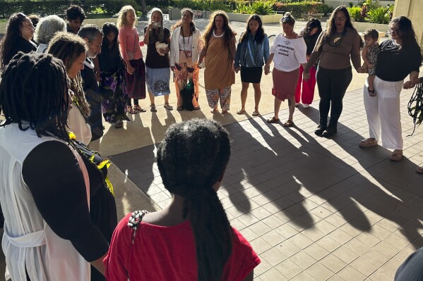 FILE - Supporters of a lawsuit challenging a Hawaii midwife licensure law gather outside a courthouse in Honolulu, June 10, 2024. On Monday, July 22, a Hawaii judge temporarily blocked the state from enforcing a licensure law against those who practice and teach traditional Native Hawaiian midwifery. (ĢӰԺ Photo/Jennifer Sinco Kelleher, File)