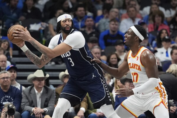 Dallas Mavericks forward Anthony Davis (3) keeps the ball from Atlanta Hawks forward Onyeka Okongwu (17) during the first half of an NBA basketball game in Dallas, Wednesday, April 2, 2025. (AP Photo/LM Otero)