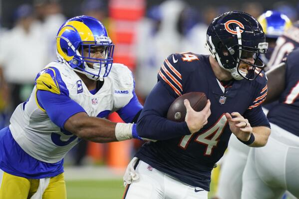 Chicago Bears quarterback Andy Dalton, right, is hauled down by Los Angeles Rams defensive end Aaron Donald during the second half of an NFL football game Sunday, Sept. 12, 2021, in Inglewood, Calif. (AP Photo/Jae C. Hong)