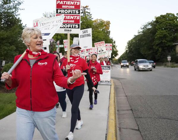 Mary Turner, president of the Minnesota Nurses Association, left, joins nurses striking Monday, Sept. 12, 2022 outside North Memorial Health Hospital in Robbinsdale, Minn. Nurses launched a three-day strike over issues of pay and what they say is understaffing that has been worsened by the strains of the coronavirus pandemic. (David Joles/Star Tribune via AP)