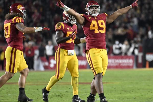 FILE - Southern California defensive lineman Tuli Tuipulotu celebrates a stop of California on fourth down during the first half of an NCAA college football game Saturday, Nov. 5, 2022, in Los Angeles. USC has created more turnovers and had more sacks in its first season with defensive coordinator Alex Grinch. (AP Photo/John McCoy)