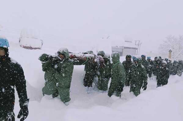 In this handout photo supplied by the Indian Army, a team carries out rescue operations for trapped construction workers who were swept away by an avalanche near the Mana Pass in northern Uttarakhand state in Chamoli district, India, Friday, Feb. 28, 2025. (Indian Army via AP)