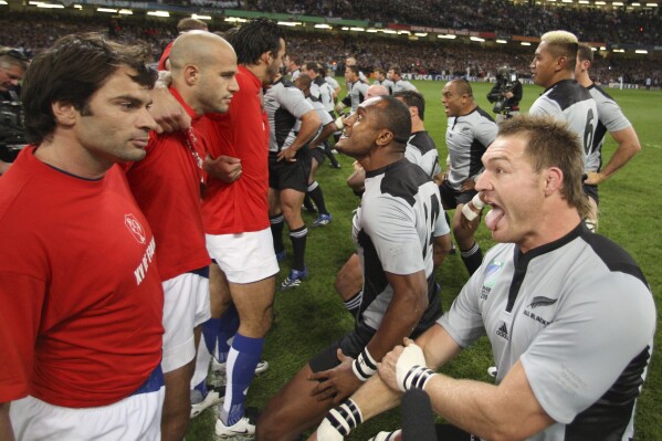 FILE - French players, left, stand close to their New Zealand counterparts who perform their pre-match Haka before the Rugby World Cup quarterfinal match between France and New Zealand at the Millennium Stadium in Cardiff, Wales, on Oct. 6, 2007. New Zealand rugby teams have been performing the haka before matches for 135 years. (AP Photo/Ross Land, Pool, File)