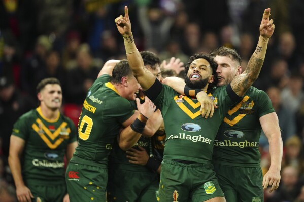 FILE - Australia's Josh Addo-Carr celebrates at the end of the Rugby League World Cup final match between Australia and Samoa at the Old Trafford Stadium in Manchester, England, Saturday, Nov. 19, 2022. When deciding whether to try to expand its impact to the United States, Australia's National Rugby League used a distinctly American sport as a model. A doubleheader Saturday night, March 2, 2024, at Las Vegas' Allegiant Stadium, which hosted the Super Bowl on Feb. 11, will be televised nationally in the U.S. on FS1.(AP Photo/Jon Super, File)