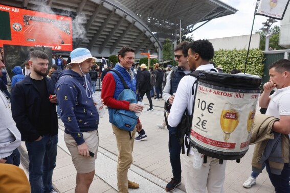 Tennis fans queue to buy beer during second round matches of the French Open tennis tournament at the Roland Garros stadium in Paris, Thursday, May 30, 2024. One player said a French Open spectator threw a piece of gum toward him. Another, No. 1-ranked Iga Swiatek, chastised the crowd at the main stadium for making too much noise during points. So the Grand Slam tournament decided enough was enough: As of Thursday, fans are banned from having alcohol in the stands. (AP Photo/Jean-Francois Badias)