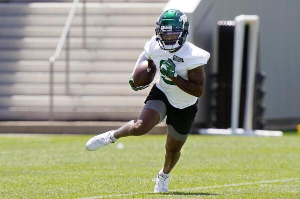 New York Jets wide receiver Elijah Moore carries the ball after catching a pass during an NFL football practice, Thursday, May 27, 2021, in Florham Park, N.J. (AP Photo/Kathy Willens)