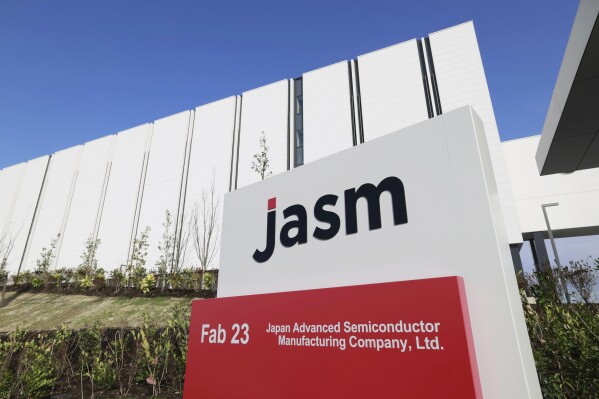 This photo shows a sign of a newly built plant to be run by Japan Advanced Semiconductor Manufacturing Company, Ltd. (JASM), a subsidiary of Taiwan Semiconductor Manufacturing Co. (TSMC), in Kikuyo town, a suburb of Kumamoto, southwestern Japan, Saturday, Feb. 24, 2024. TSMC opened Saturday in an official ceremony its first semiconductor plant in Japan as part of its ongoing global expansion. JASM is set to be up and running later this year (Kyodo News via AP)