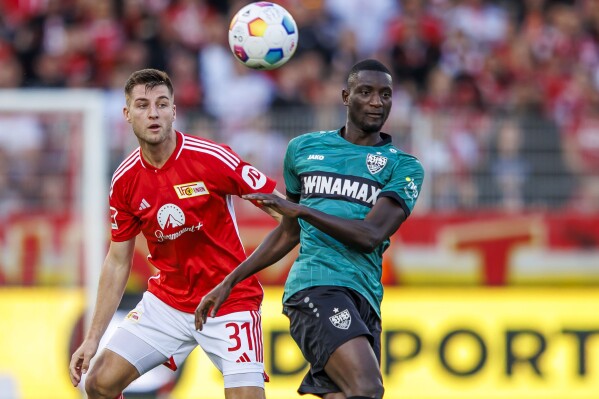 Berlin's Robin Knoche, left, fights for the ball against VfB Stuttgart's Serhou Guirassy. during the Bundesliga soccer match between Union Berlin and VfB Stuttgart in Berlin Saturday, Oct. 21, 2023. (Andreas Gora/dpa via AP)