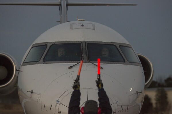 FILE - A Skywest Airlines aircraft is guided on the tarmac at Barkley Regional Airport in Paducah, Ky., Dec. 27, 2017. Laser strikes aimed at aircraft are at an all-time high. That's according to the Federal Aviation Administration. The FAA said Wednesday, Jan. 31, 2024 that it received about 13,300 reports of lasers aimed at aircraft — including airliners — last year. That's a record and a 41% increase over the previous year. FAA Administrator Mike Whitaker says pointing a laser at a plane puts everyone on the plane and on the ground at risk. Authorities blame the surge in laser incidents on factors including the widespread sale of inexpensive lasers in stores and online. (Ryan Hermens/The Paducah Sun via AP, file)