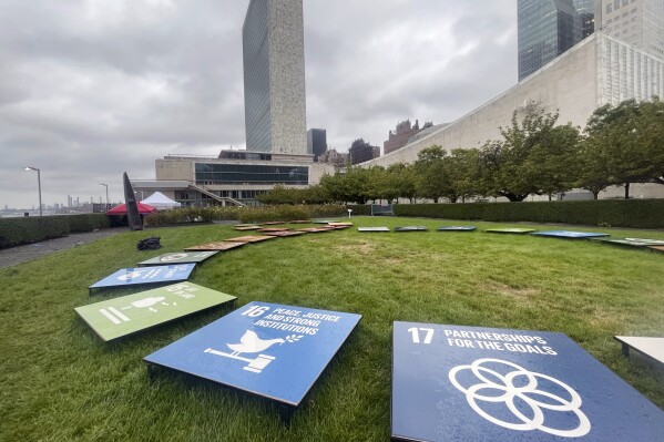 Tiles depicting the United Nations’ Sustainable Development Goals are displayed outside the U.N. General Assembly Hall at the United Nations, Saturday, Sept. 23, 2023. The U.N. Secretariat Building is shown in the background. (AP Photo/Ted Anthony)