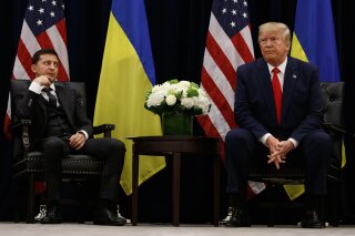 FILE - In this Sept. 25, 2019, file photo, President Donald Trump meets with Ukrainian President Volodymyr Zelenskiy at the InterContinental Barclay New York hotel during the United Nations General Assembly, in New York. It’s the story of a president who either had a “perfect phone call” with Ukraine or abused his power and should be removed from office. What to watch as presidential impeachment arguments get underway in the Senate for only the third time in American history. (AP Photo/Evan Vucci, File)