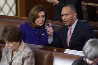 FILE - Rep. Hakeem Jeffries, D-N.Y., right, talks with Rep. Nancy Pelosi, D-Calif., during the eighth vote in the House chamber as the House meets for the third day to elect a speaker and convene the 118th Congress in Washington, on Jan. 5, 2023. Democrats are basking in having displayed remarkable unity, with every one of their members backing party leader Hakeem Jeffries for the House speakership again and again and again. Speculation Biden might have to overcome a hard Democratic primary has also quieted. (AP Photo/Alex Brandon, File)