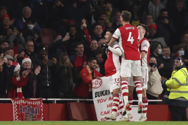 Arsenal's Gabriel Martinelli, left, celebrates his goal with his teammates against West Ham during the English Premier League soccer match between Arsenal and West Ham United at Emirates stadium in London, Wednesday, Dec. 15, 2021. (AP Photo/Ian Walton)