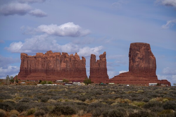 FILE - Homes and other structures are seen in Monument Valley, Ariz., on the Navajo reservation, April 19, 2020. Monument Valley and various other parks on the Navajo Nation will be closed Saturday, Oct. 14, 2023, due to the "Ring of Fire" solar eclipse. (AP Photo/Carolyn Kaster, File)