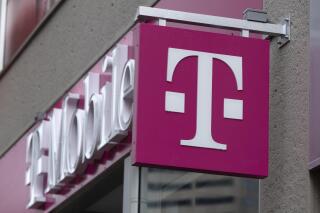 FILE - The T-Mobile logo is seen on a storefront, on Oct. 14, 2022, in Boston. Customers of the wireless provider reported widespread service outages in the U.S. late Monday, Feb. 13, 2023, according to websites tracking service interruptions. (AP Photo/Michael Dwyer, File)