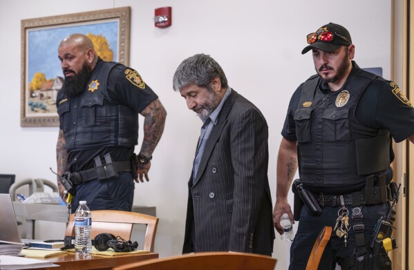 Muhammad Syed enters the court room before opening statements at the Bernalillo County Courthouse in Downtown Albuquerque, N.M,, on Tuesday, March 12, 2024. Syed, an Afghan refugee, is accused in the slayings of three Muslim men in Albuquerque. (Chancey Bush/The Albuquerque Journal via AP, Pool)