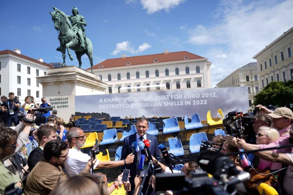 Andriy Shevchenko, Ukrainian football legend and UAF President, talks to journalists as he presents an installation ahead of the Group E match between Romania and Ukraine at the Euro 2024 soccer tournament in Munich, Germany, Monday, June 17, 2024.A poignant installation has been unveiled ahead of Ukraine’s first match at the European Championship. A destroyed stand from Kharkiv’s Sonyachny stadium that was built for Euro 2012 has been displayed in a square in Munich ahead of the team’s opener against Romania. (AP Photo/Ariel Schalit)