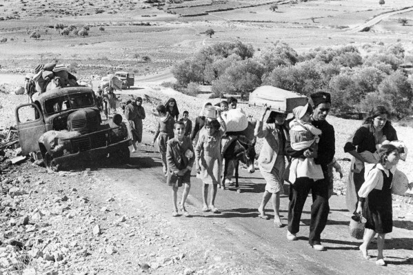 Palestinian villagers flee during fighting between Israeli and Arab troops on Nov. 4, 1948. (AP Photo/Jim Pringle, File)