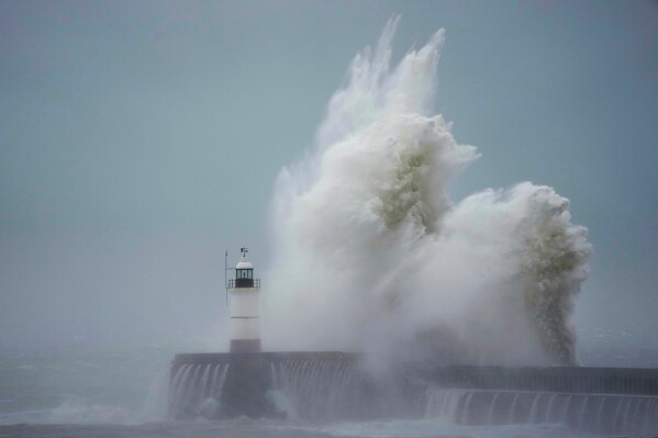 Waves crash over Newhaven Lighthouse and the harbour wall in Newhaven, southern England, Thursday, Nov. 2, 2023. Winds up to 180 kilometers per hour (108 mph) slammed France's Atlantic coast overnight as Storm Ciaran lashed countries around western Europe, uprooting trees, blowing out windows and leaving 1.2 million French households without electricity Thursday. Strong winds and rain also battered southern England and the Channel Islands, where gusts of more than 160 kph (100 mph) were reported. (AP Photo/Kin Cheung)