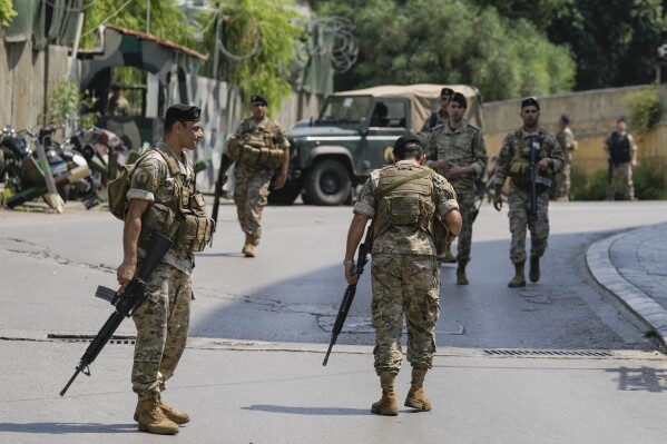 Lebanese security stand guard on a road that leads to the U.S. Embassy in Aukar, a northern suburb of Beirut, Lebanon, Wednesday, June 5, 2024. (AP Photo/Bilal Hussein)