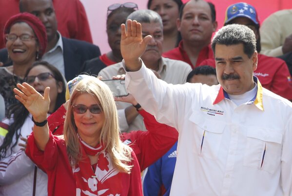 FILE - In this May 20, 2109 file photo, Venezuela's President Nicolas Maduro and his wife Cilia Flores wave to supporters outside Miraflores presidential palace in Caracas, Venezuela. A nephew of Venezuela’s first lady appealed on Tuesday, Aug. 25, 2020, to the U.S. Supreme Court an 18-year sentence for conspiring to smuggle 800 kilograms of cocaine into the U.S. (AP Photo/Ariana Cubillos, File)
