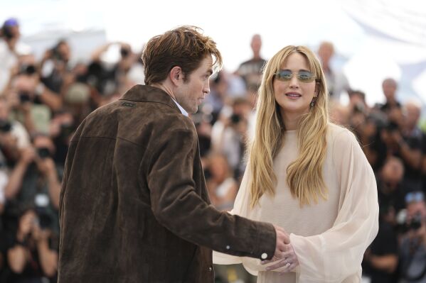 Robert Pattinson, left, and Jennifer Lawrence pose for photographers at the photo call for the film 'Die, My Love' at the 78th international film festival, Cannes, southern France, Sunday, May 18, 2025. (Photo by Scott A Garfitt/Invision/AP)