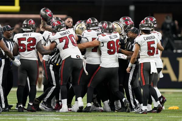 Officials break a brawl between the New Orleans Saints and the Tampa Bay Buccaneers during the second half of an NFL football game in New Orleans, Sunday, Sept. 18, 2022. (AP Photo/Gerald Herbert)