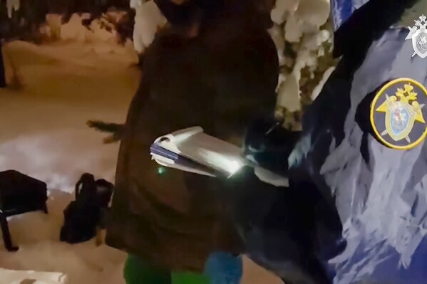 In this photo taken from video released by Russian Investigative Committee on Wednesday, Dec. 6, 2023, investigators work at the place where Illia Kyva was killed in a cottage village near Moscow, Russia. Kyva, a former member of Ukraine's parliament who had called for Kyiv to surrender when Russian troops invaded the country in February 2022, was found on Wednesday with a gunshot wound to the head in a cottage village near Moscow. (Russian Investigative Committee via AP)