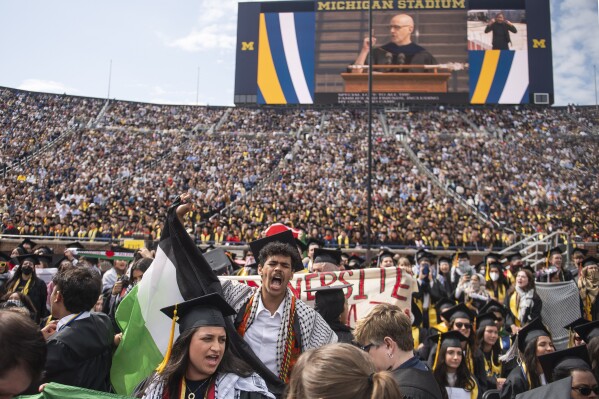 Rawan Antar, 21, center, chants in support of Palestinians during the University of Michigan's Spring 2024 Commencement Ceremony at Michigan Stadium in Ann Arbor, Mich., on Saturday, May 4, 2024. (Katy Kildee/Detroit News via AP)