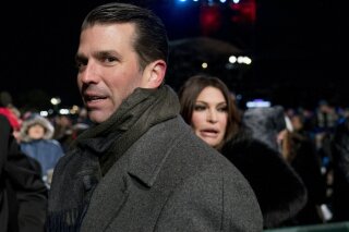 
              FILE - In this Nov. 28, 2018, file photo, Donald Trump Jr., center, and Kimberly Guilfoyle, right, depart following the National Christmas Tree lighting ceremony at the Ellipse near the White House in Washington. Senate investigators have evidence revealing the identities behind two mysterious phone calls that Donald Trump Jr. had with blocked numbers during the 2016 presidential campaign, just days before he met with a Russian lawyer promising dirt on Democratic candidate Hillary Clinton. According to phone records provided to Congress, Trump Jr. spoke to Howard Lorber, a New York real estate executive, and Brian France, the former chairman of NASCAR, two people familiar with the records told The Associated Press. (AP Photo/Andrew Harnik, File)
            