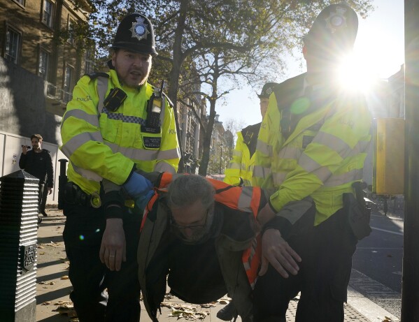 Police arrests protesters of the climate campaigners group Just Stop Oil in London, Thursday, Nov. 23, 2023. (AP Photo/Frank Augstein)