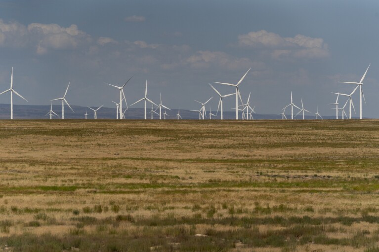 Wind turbines are seen from Interstate-84, Sunday, July 9, 2023, near Hammett, Idaho. (AP Photo/Lindsey Wasson)