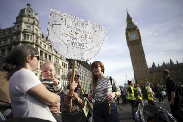 Demonstrators take part in the March of the Mummies national protest in central London, Saturday, Oct. 29 2022. The protest is organized by Pregnant Then Screwed to demand Government reform on childcare, parental leave and flexible working. (Aaron Chown/PA via AP)