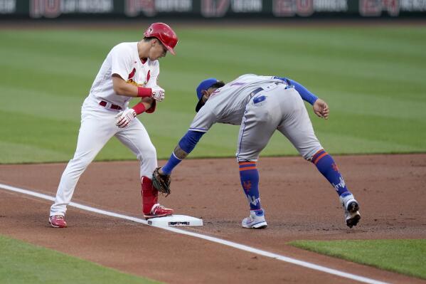 St. Louis Cardinals' Tommy Edman, left, arrives at third for a triple ahead of the tag from New York Mets third baseman Jonathan Villar during the first inning of a baseball game Monday, May 3, 2021, in St. Louis. (AP Photo/Jeff Roberson)