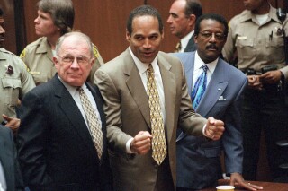 FILE - In this Oct. 3, 1995, file photo, O.J. Simpson reacts as he is found not guilty in the death of his ex-wife Nicole Brown Simpson and her friend Ron Goldman in Los Angeles, as defense attorneys F. Lee Bailey, left, and Johnnie L. Cochran Jr., stand with him. Social media users are falsely claiming that Simpson admitted on X to the killings before he died on Wednesday. (Myung J. Chun/Los Angeles Daily News via AP, Pool, File)