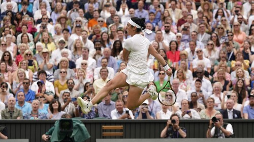 Tunisia's Ons Jabeur kicks the ball after failing to chase down a volley by Aryna Sabalenka of Belarus in their women's singles semifinal match on day eleven of the Wimbledon tennis championships in London, Thursday, July 13, 2023. (AP Photo/Alberto Pezzali)