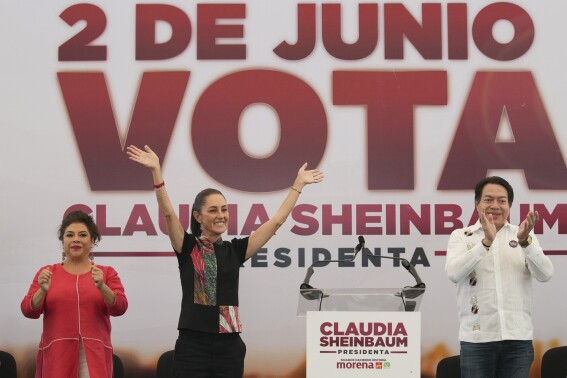 FILE - Ruling party presidential candidate Claudia Sheinbaum, center left, greets supporters at a campaign rally, flanked by mayoral candidate Clara Brugada and Morena party president Mario Delgado, in Mexico City, May 16, 2024. (AP Photo/Marco Ugarte, File)