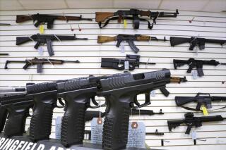 FILE - Assault weapons and hand guns are seen for sale at Capitol City Arms Supply on Jan. 16, 2013, in Springfield, Ill. Enforcement on a ban on dozens of semiautomatic rifles and handguns is under scrutiny after a state appellate court endorsed a temporary restraining order on Jan. 31, 2023, in a case filed by thousands of advocates and led by Accuracy Firearms, a dealer in Effingham, 101 miles (162 kilometers) northeast of St. Louis. (AP Photo/Seth Perlman, File)