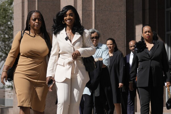 Arian Simone, second left, one of the co-founders and CEOs of The Fearless Fund, walks out of the James Lawrence King Federal Building following a hearing, Wednesday, Jan. 31, 2024, in Miami. A federal appeals court in Miami heard oral arguments Wednesday in a lawsuit against The Fearless Fund, a small venture capital firm that provides early stage funding to businesses owned by women of color, and which conservative activists are targeting as part of a growing legal backlash against corporate diversity programs. (AP Photo/Rebecca Blackwell)
