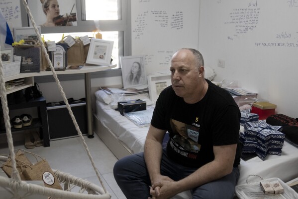 Shlomi Berger sits in his daughter's bedroom in Holon, Israel, Wednesday, April 17, 2024. Agam, 19, was abducted two days after the start of her army service along the border with Gaza during a cross-border attack by Hamas on Oct. 7, 2023. "The Passover story says we come from slaves to free people, so this is a parallel story," Berger said. "This is the only thing I believe that will happen. That Agam will get out from darkness to light. She and all of the other hostages." (AP Photo/Maya Alleruzzo)