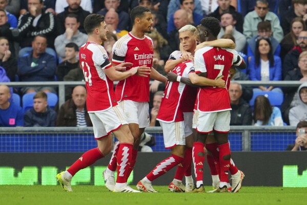 Arsenal's Leandro Trossard, second right, celebrates after scoring his side's opening goal during the English Premier League soccer match between Everton and Arsenal at the Goodison Park stadium in Liverpool, England, Sunday, Sept. 17, 2023. (AP Photo/Jon Super)