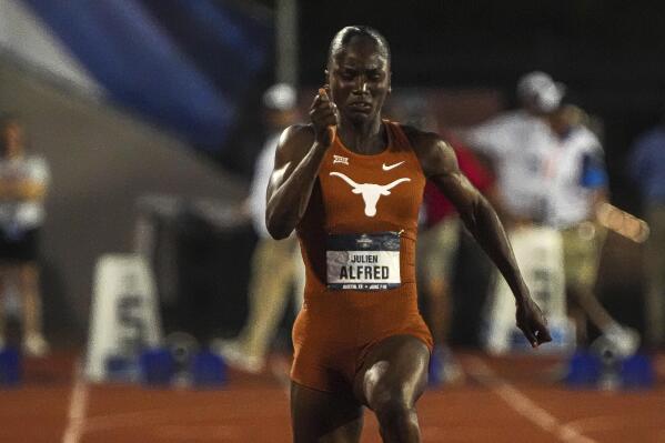 Texas athlete Julien Alfred competes in the 100-meter dash during the NCAA outdoor track and field championships Saturday, June 10, 2023, in Austin, Texas. (Aaron E. Martinez/Austin American-Statesman via AP)