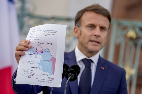 French President Emmanuel Macron shows a map during a press conference at the German government guest house in Meseberg, north of Berlin, Germany, Tuesday, May 28, 2024. (AP Photo/Ebrahim Noroozi)