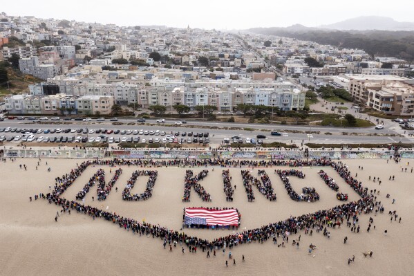 People form a human banner at Ocean Beach during the "No Kings" protests in San Francisco on Saturday, June 14, 2025. (Santiago Mejia/San Francisco Chronicle via AP)