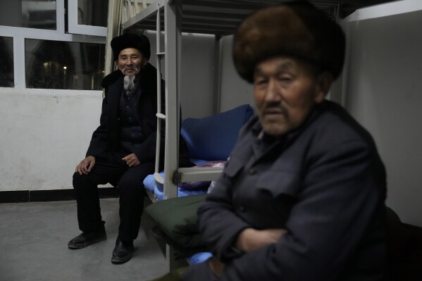 Elderly men rest at a school dormitory used as shelter for residents displaced in the aftermath of an earthquake in Wushi county in China's western Xinjiang region on Tuesday, Jan. 23, 2024. A magnitude 7.1 earthquake has struck a sparsely populated part of China’s western Xinjiang region, killing three people and damaging or collapsing more than 120 homes in freezing cold weather. The quake rocked a mountainous county in Aksu prefecture shortly after 2 a.m. on Tuesday. (AP Photo/Ng Han Guan)