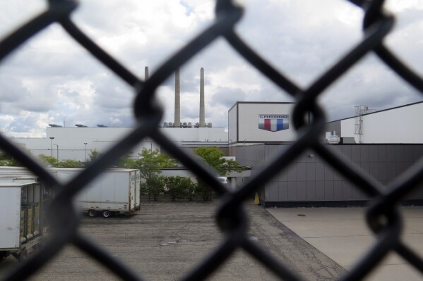 General Motor's Lansing Grand River Assembly plant is seen behind a fence , Tuesday, Sept. 12, 2023, in Lansing, Mich., where workers could soon be on the outside looking in with a potential strike set to begin on Thursday night. (AP Photo/Joey Cappelletti)