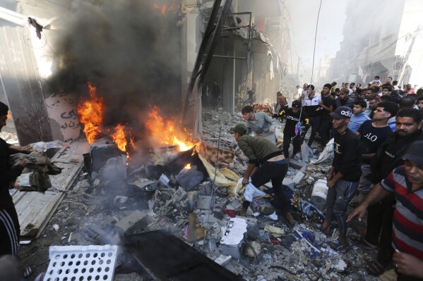 Palestinians look for survivors after an Israeli strike on Rafah, Gaza Strip, Friday, Nov. 17, 2023. (AP Photo/Hatem Ali)