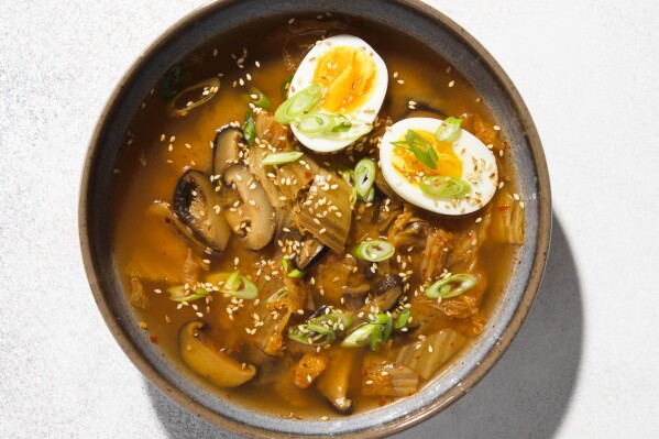 This image released by Milk Street shows a recipe for Miso, Shiitake Mushroom and Kimchi Soup. (Milk Street via AP)